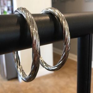 Set of two stainless steel bangle bracelets.